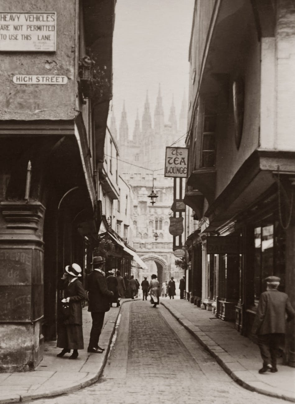 old photo of a narrow street with people