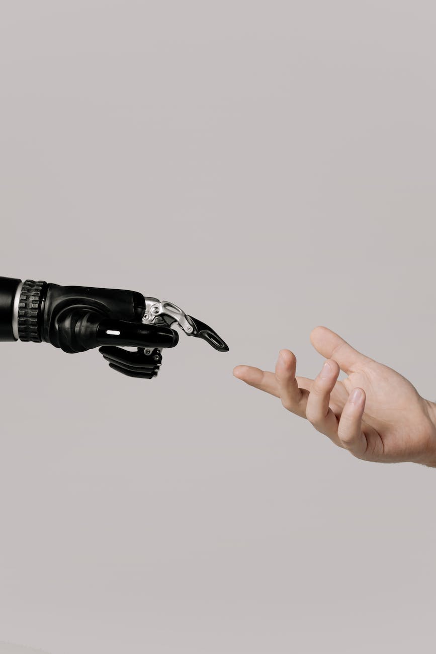 hand of a person and a bionic hand